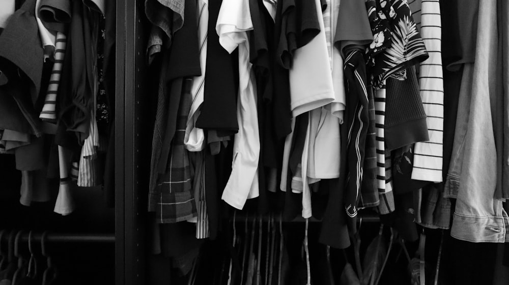 a closet filled with lots of different types of shirts
