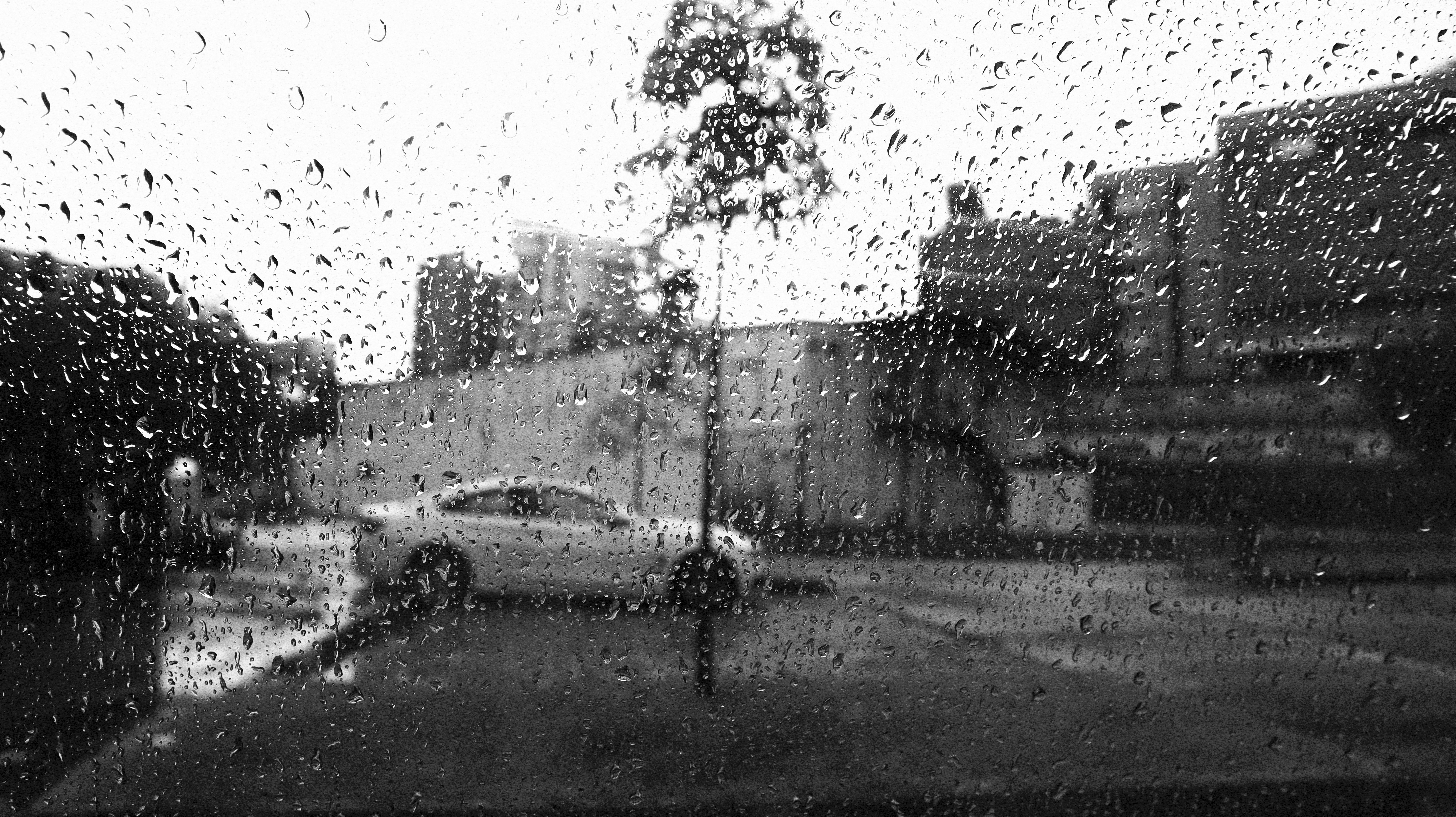a black and white photo of a rainy street