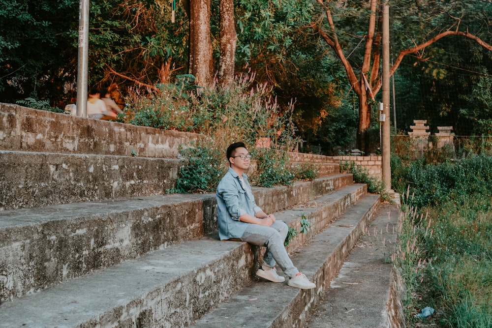 a person sitting on some steps in a park