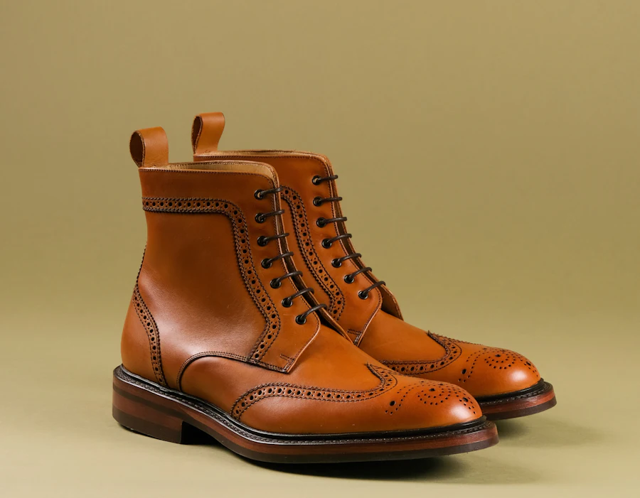 A tan leather boot against a warm ground