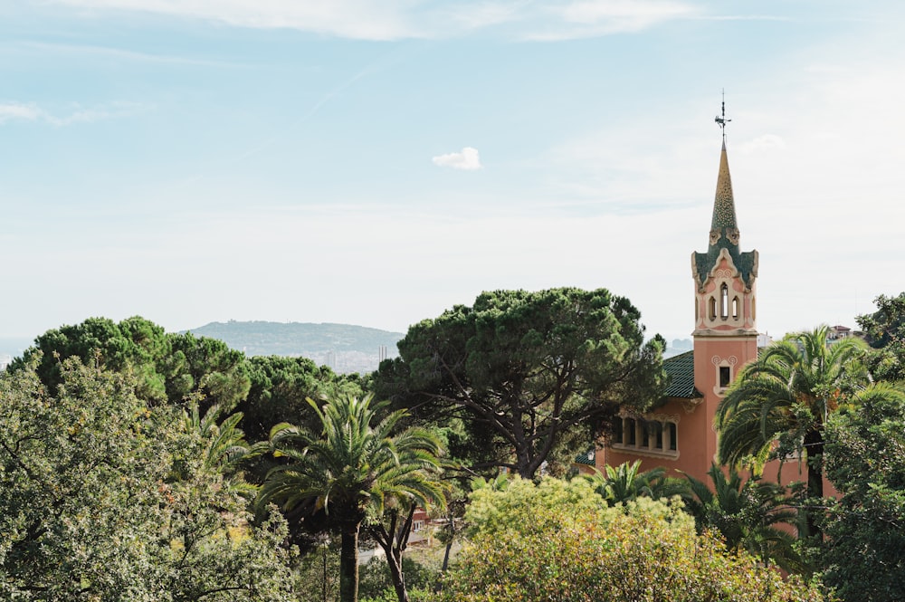 a church with a steeple surrounded by trees