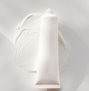 a tube of cream sitting on top of a white plate