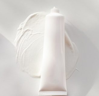 a tube of cream sitting on top of a white plate