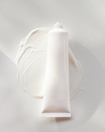 Close-up of a creamy lotion texture on a smooth surface with soft natural lighting