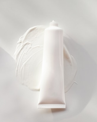 Moisturizer tube with soft lighting highlighting its smooth texture.