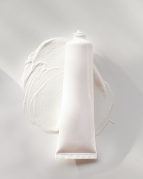 a tube of cream sitting on top of a white plate