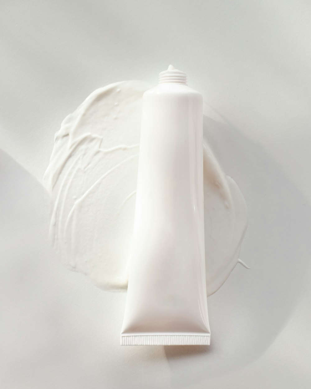 a tube of cream sitting on top of a white plate