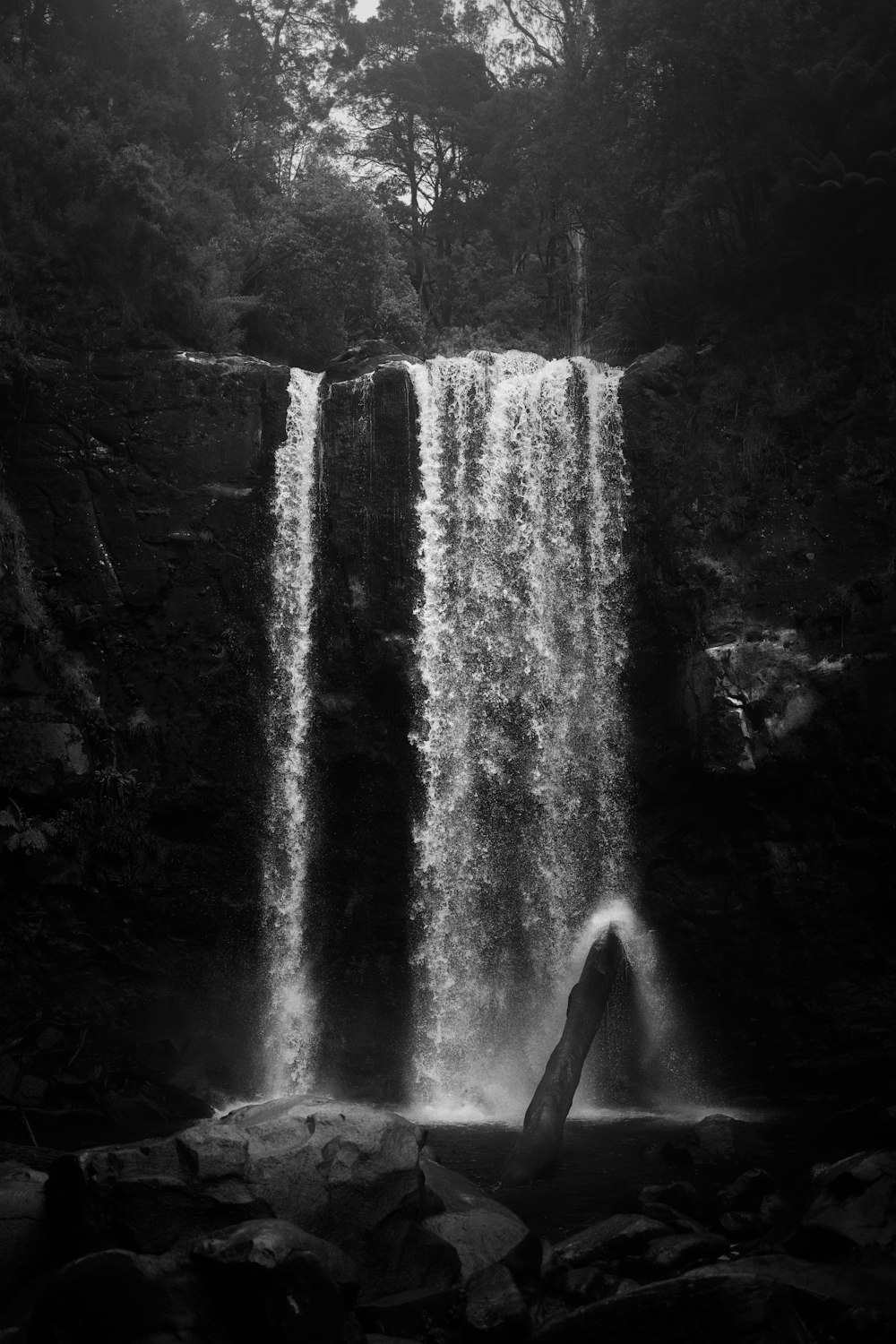 a black and white photo of a waterfall