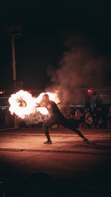 a man is doing a trick with fire