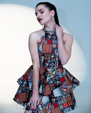 a woman wearing a dress with a pattern on it