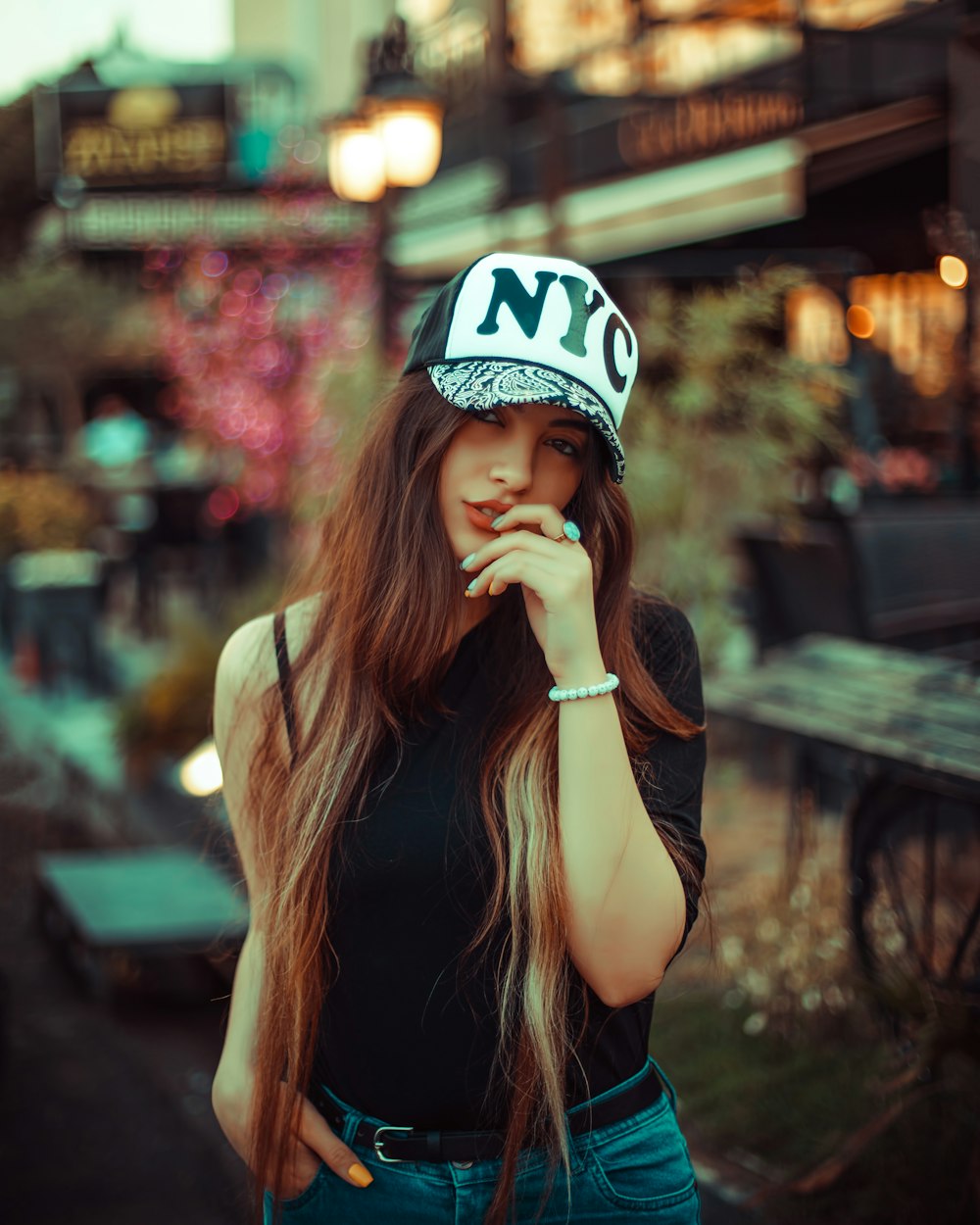 a woman with a hat on talking on a cell phone