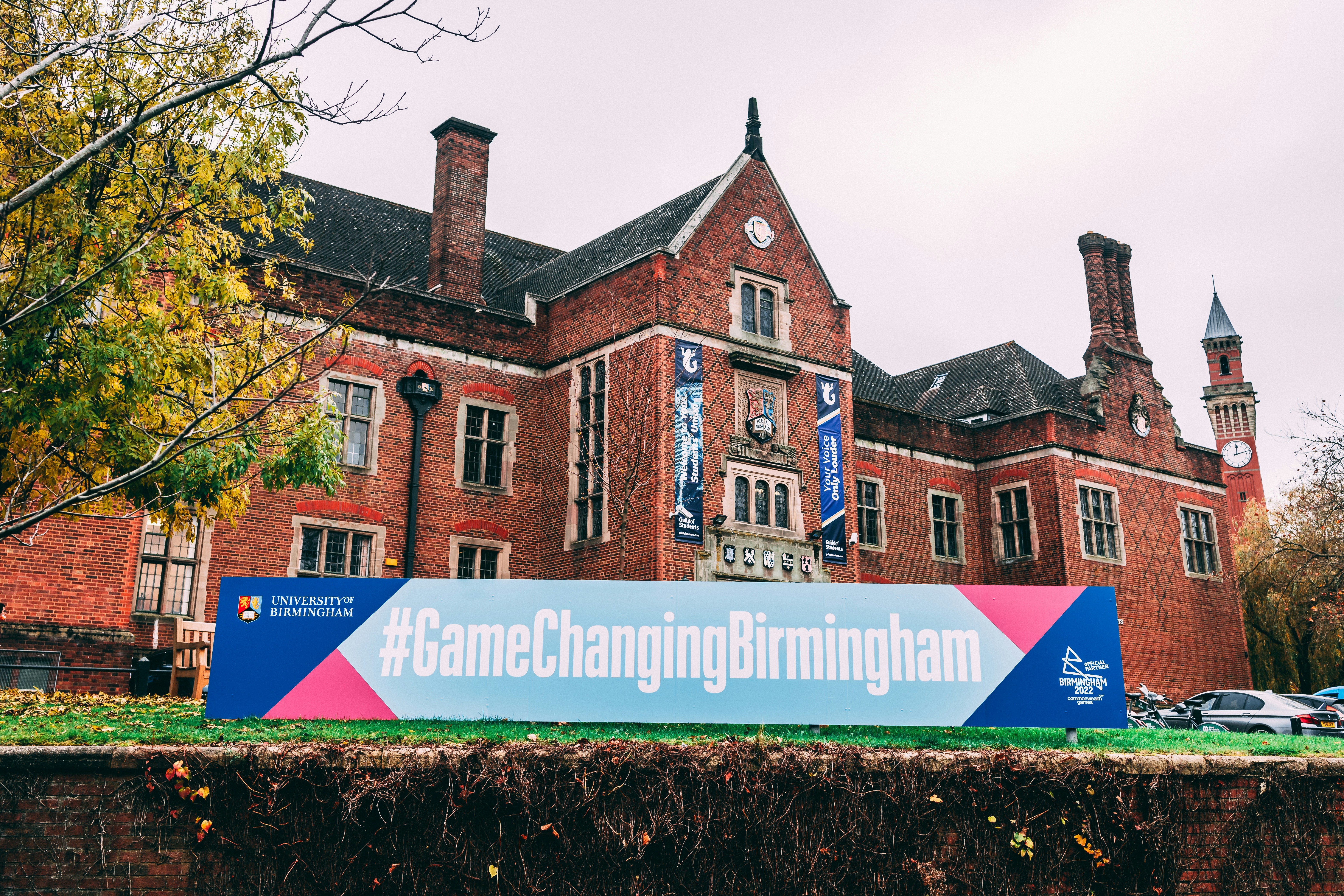 a large brick building with a sign in front of it