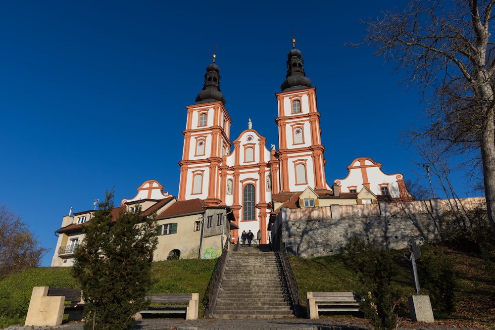 a church with a steeple on top of a hill