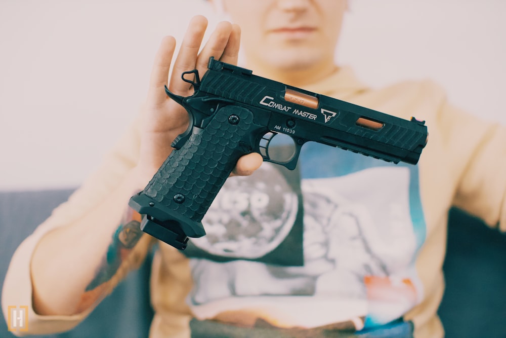 a person holding a toy gun in their hand