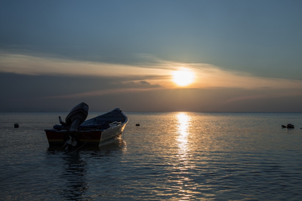 a boat sitting in the middle of a body of water