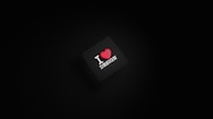 A dark background with a black square in the center. The square has the text 'I ❤️ DESIGN' with the heart symbol in red color.