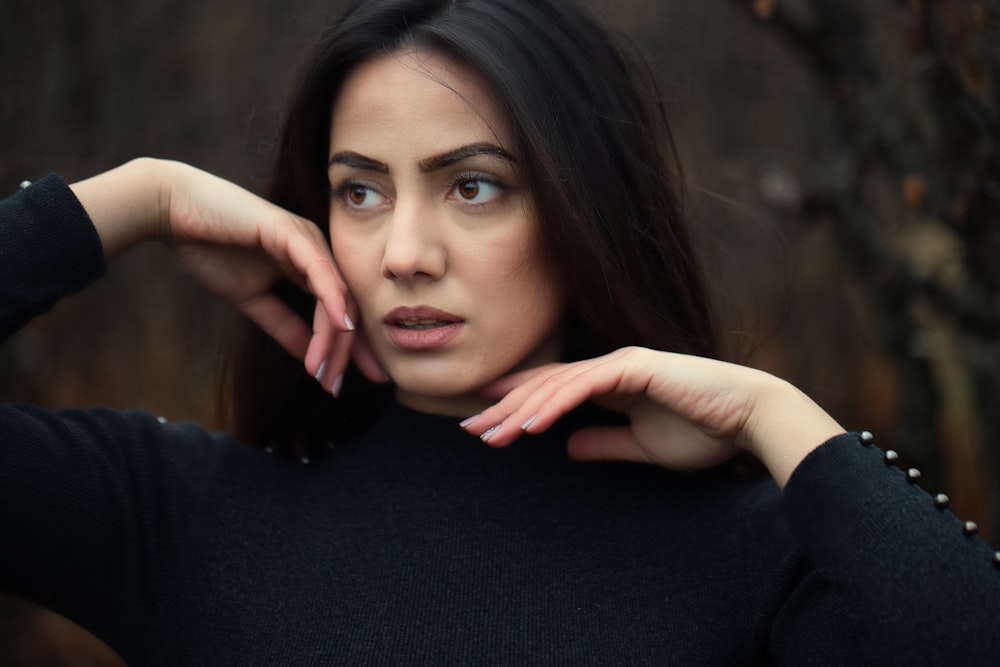 a woman in a black sweater posing for a picture