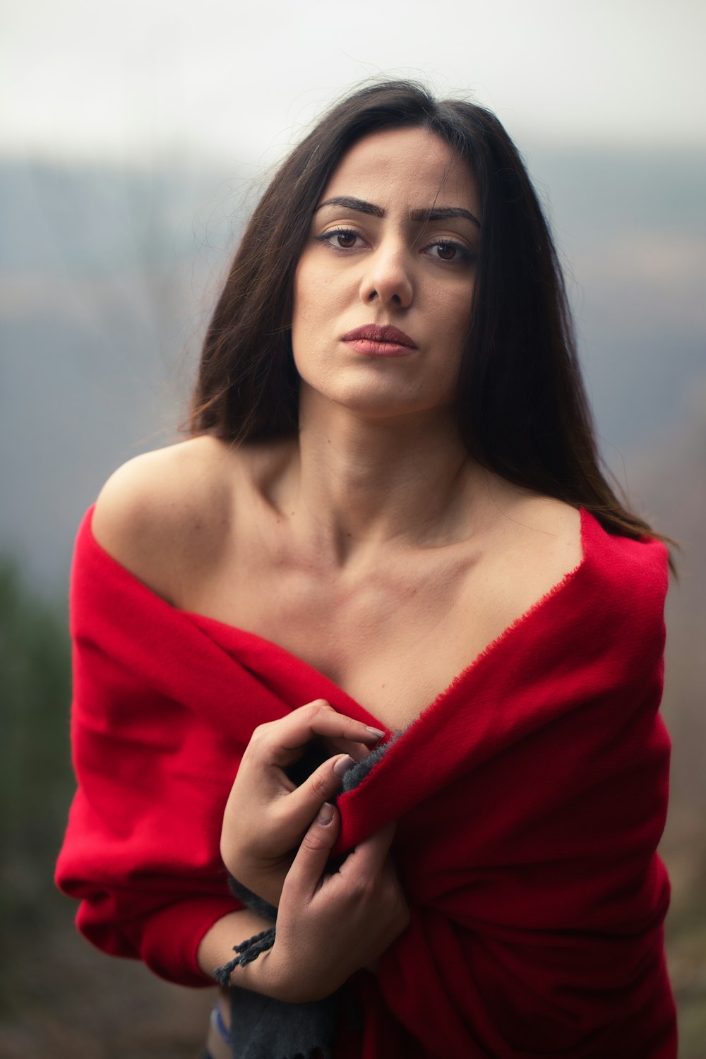 a woman in a red top is posing for a picture