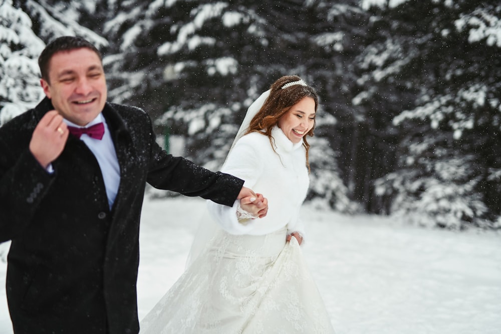 a man and a woman standing in the snow