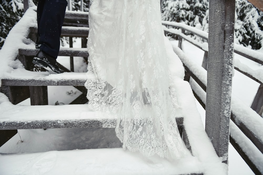 a person standing on a bridge in the snow