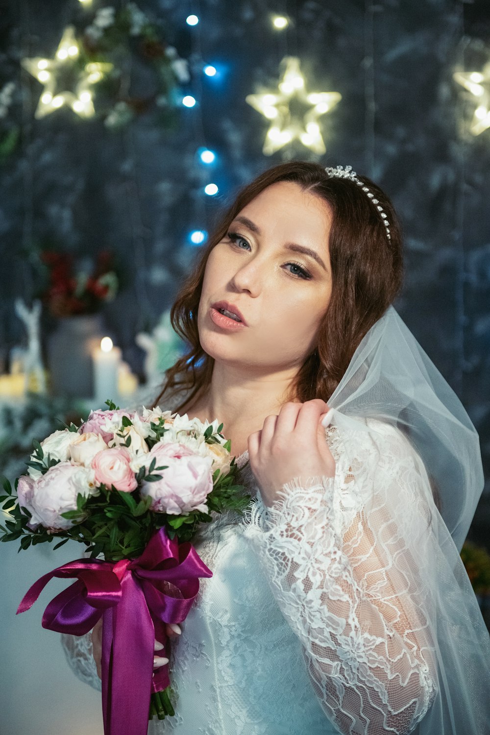 a woman in a wedding dress holding a bouquet of flowers