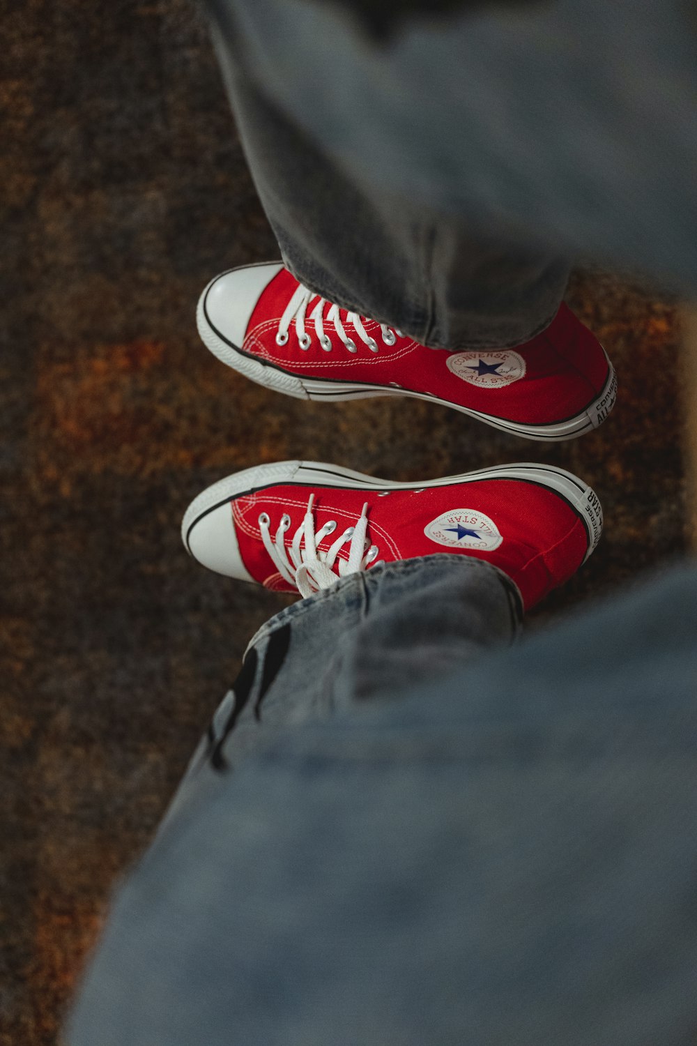a pair of red shoes with white laces