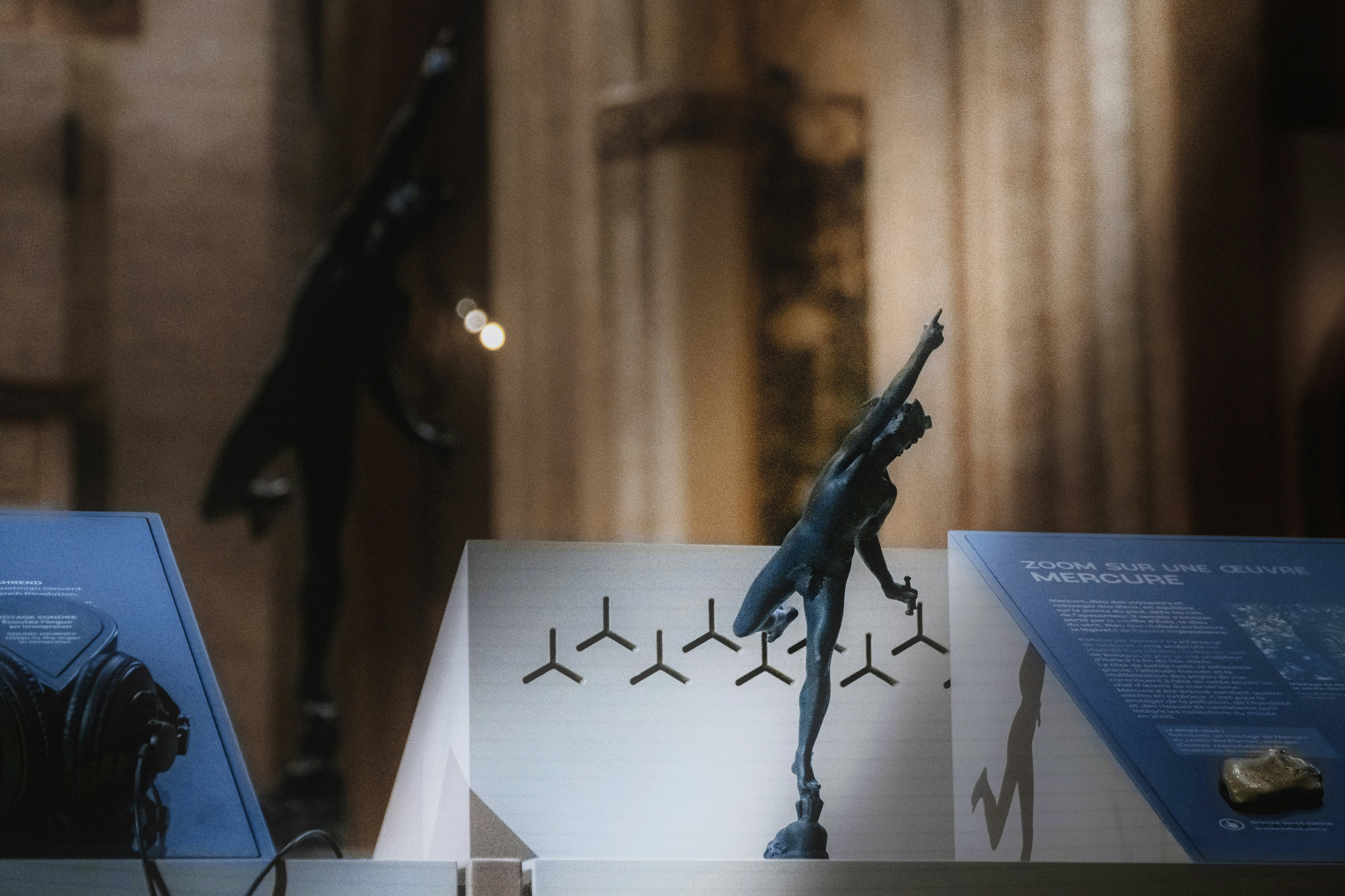 a couple of statues are on display in a museum