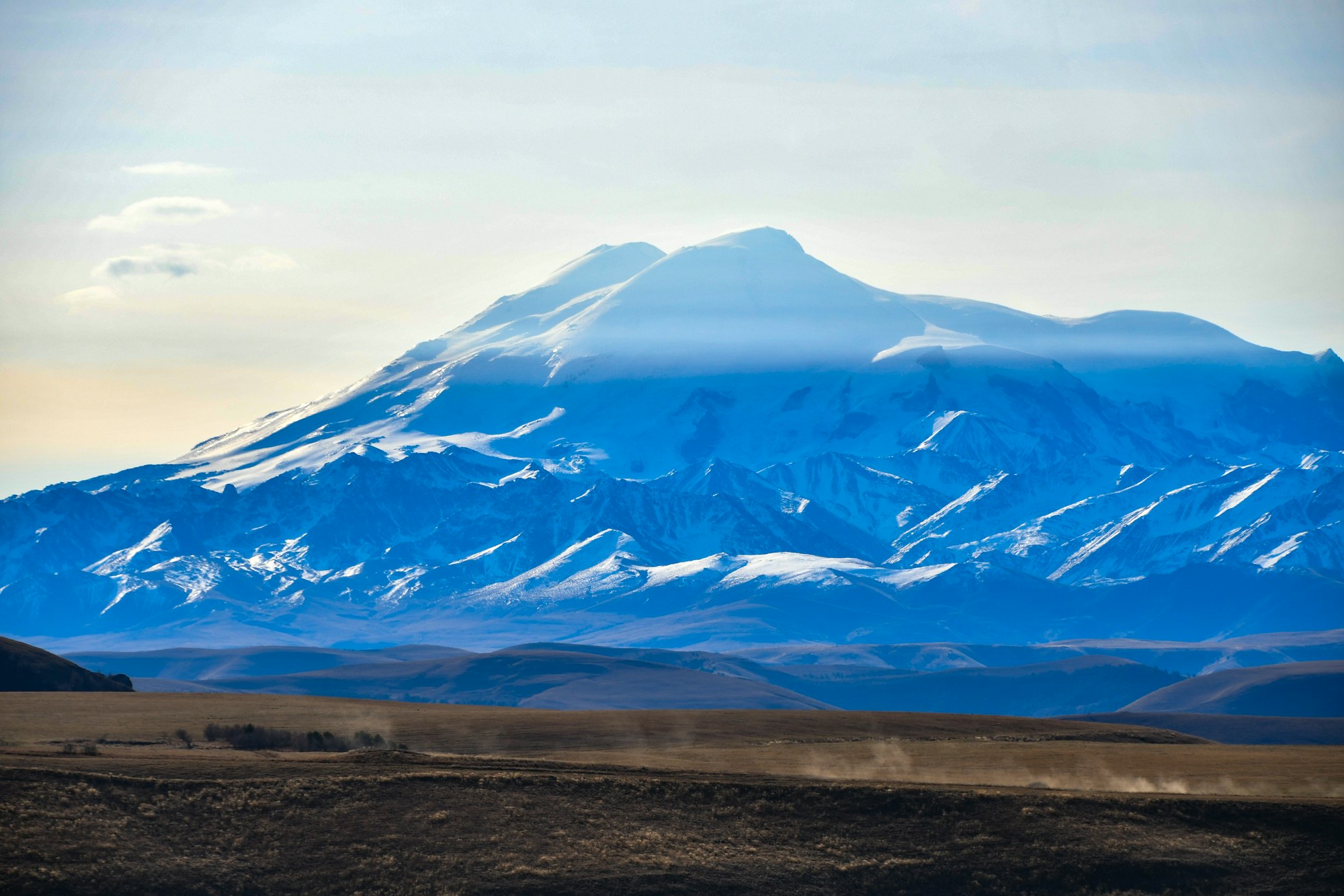 a large snow covered mountain in the distance