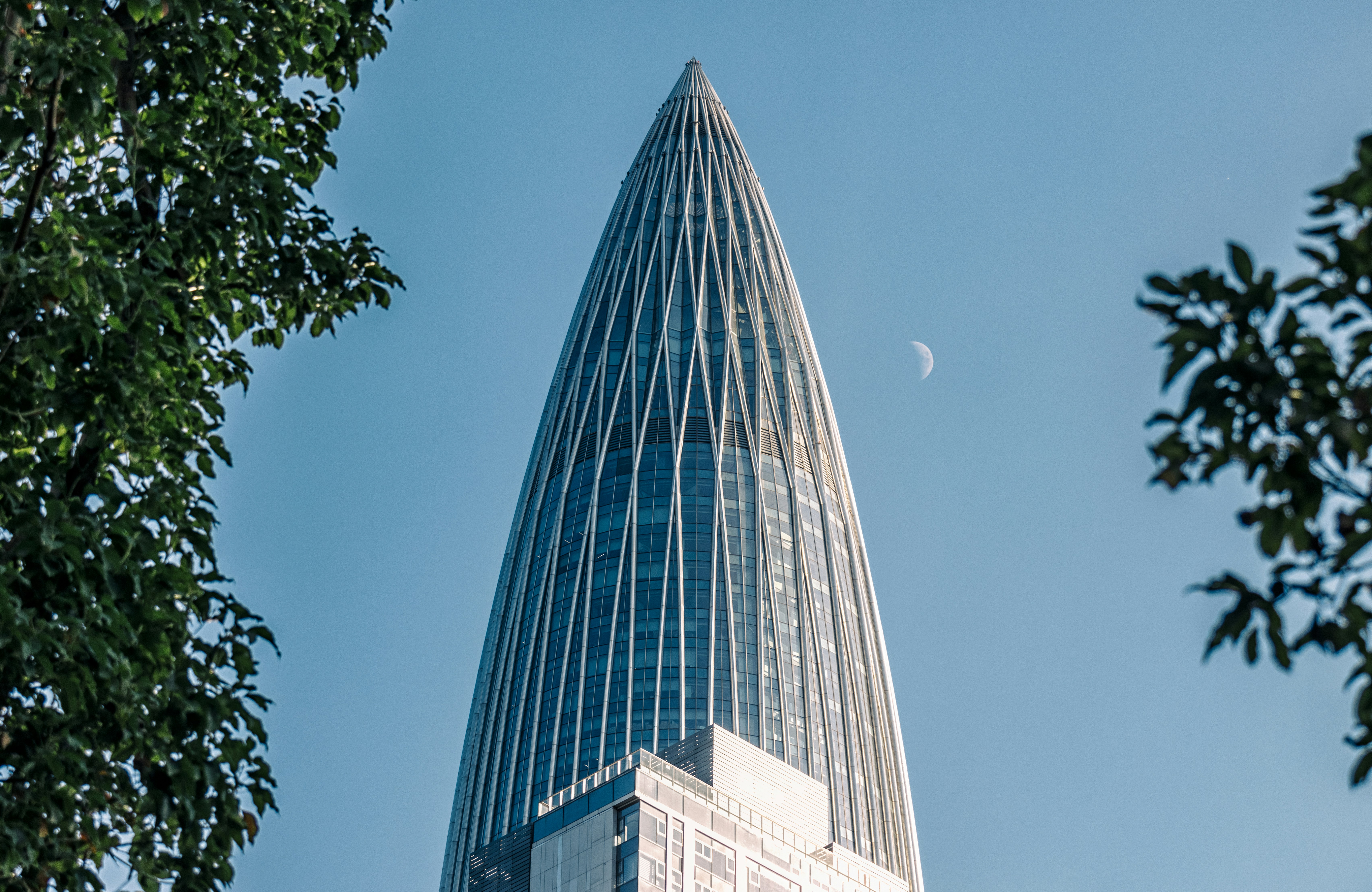 A very tall building with a half moon in the sky photo – Free 中国华润大厦 ...