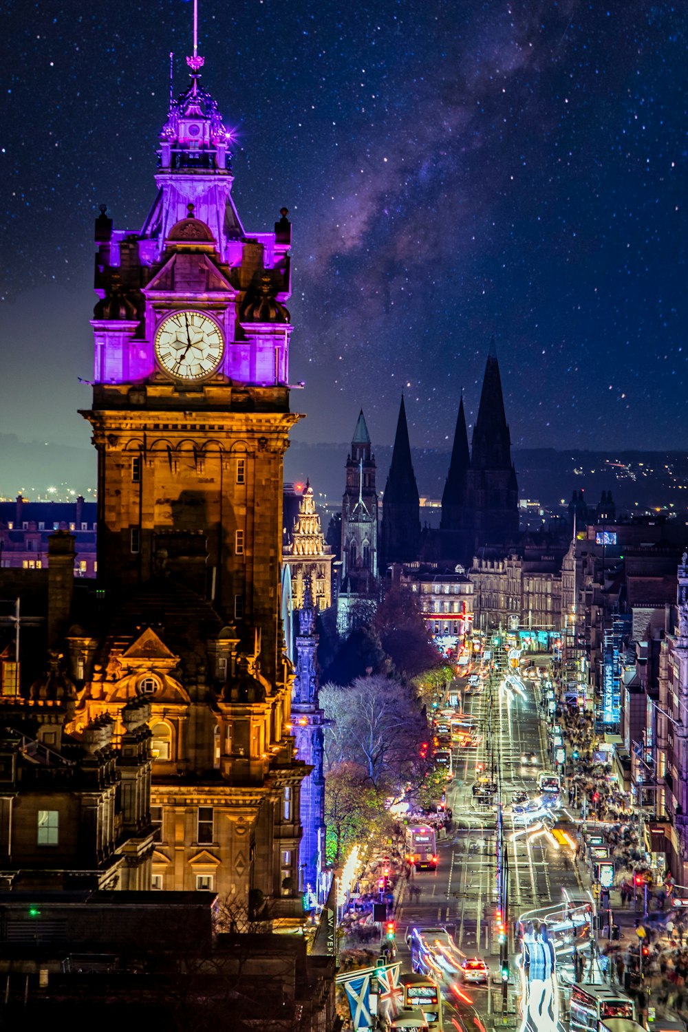a clock tower in the middle of a city at night