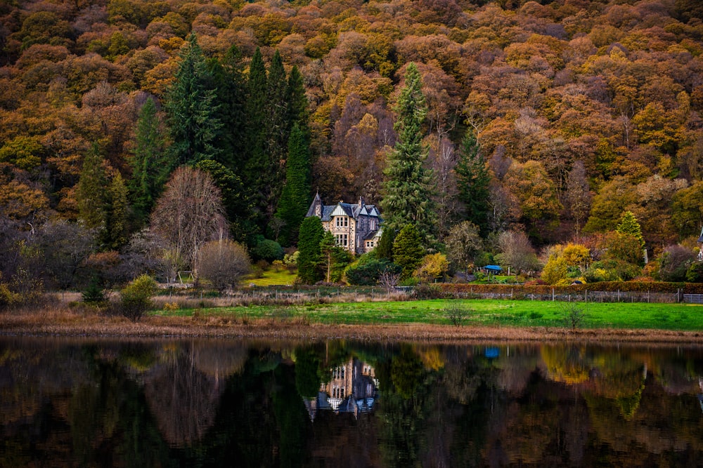 a large house sitting on top of a lush green hillside