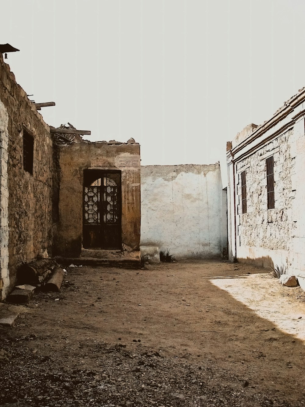 an old building with a door in the middle of it