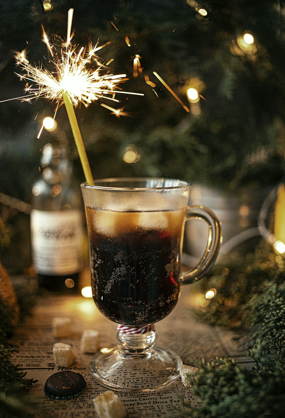 a glass filled with liquid and a sparkler