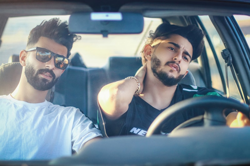 Stylish gay couple in car