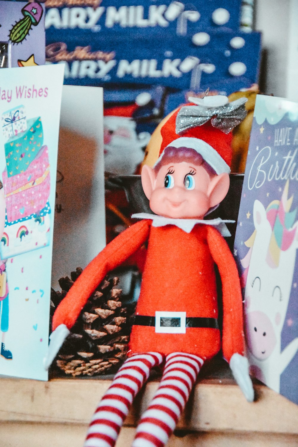 a red elf doll sitting on top of a table