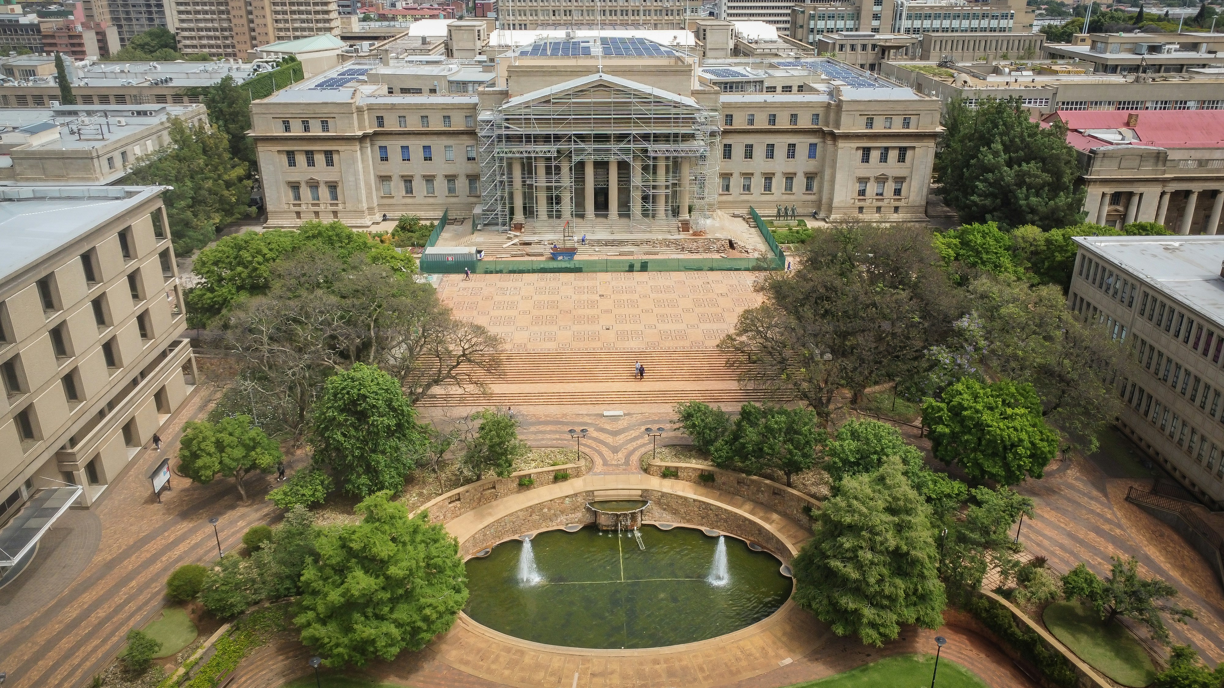 a large building with a fountain in the middle of it