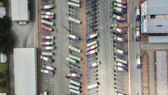 an aerial view of a parking lot filled with cars