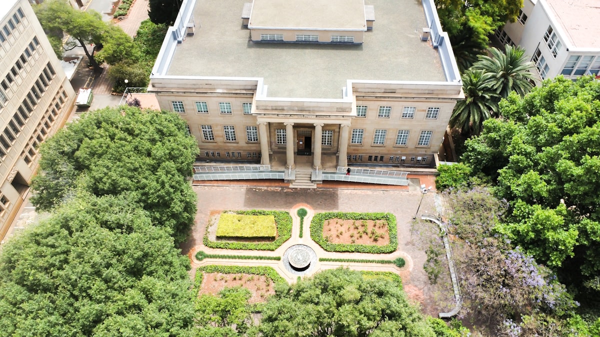 Aerial view of a college campus building surrounded by trees