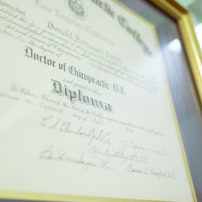 a framed diploma with a gold seal on it