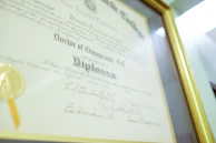 a framed diploma with a gold seal on it