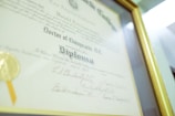 a framed diploma with a gold seal on it
