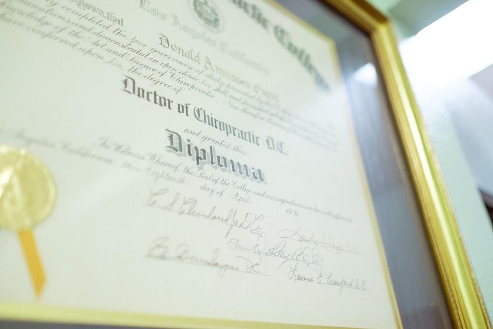 a framed diploma with a gold seal on it