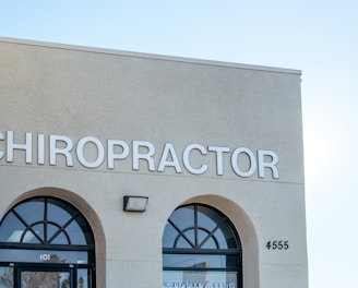 a building with two arched windows and a sign that says chiropractor