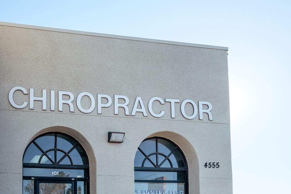 a building with two arched windows and a sign that says chiropractor