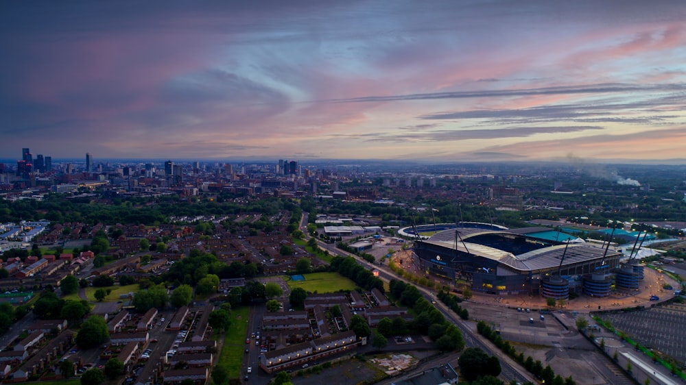 an aerial view of a stadium with a city in the background