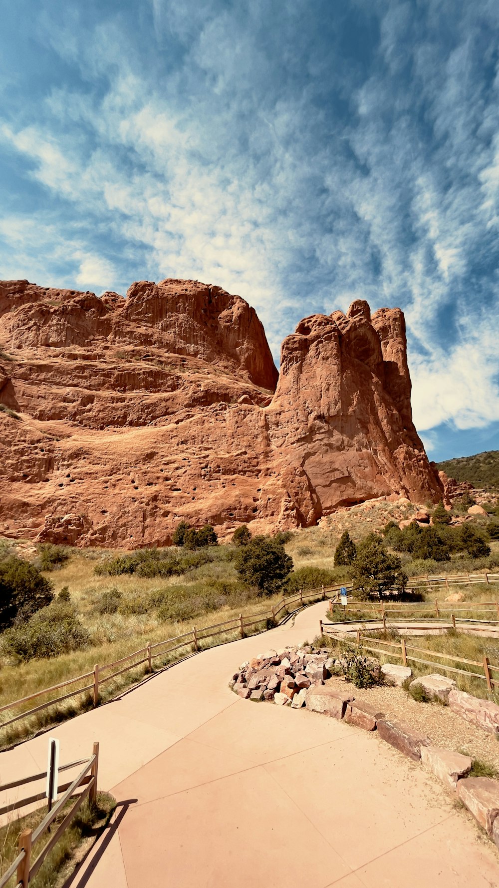 a large rock formation with a walkway leading to it