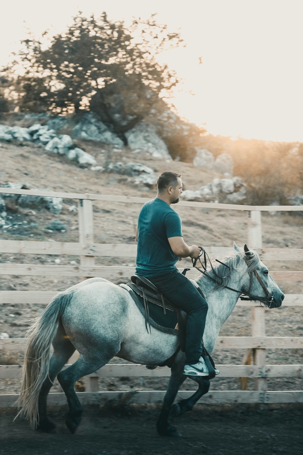 a man riding on the back of a white horse