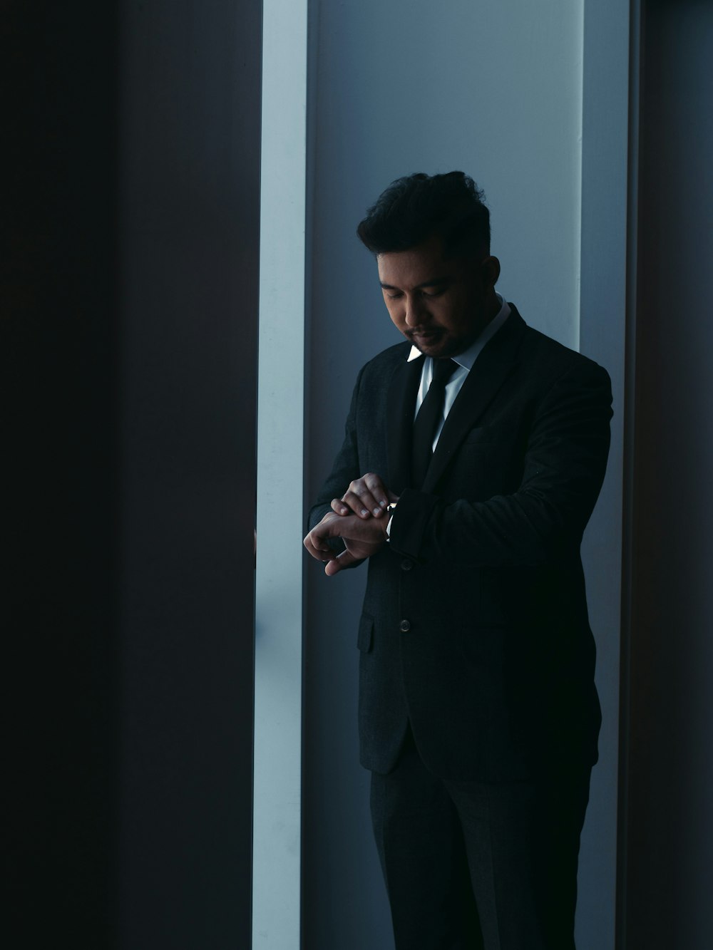 a man in a suit standing in a room