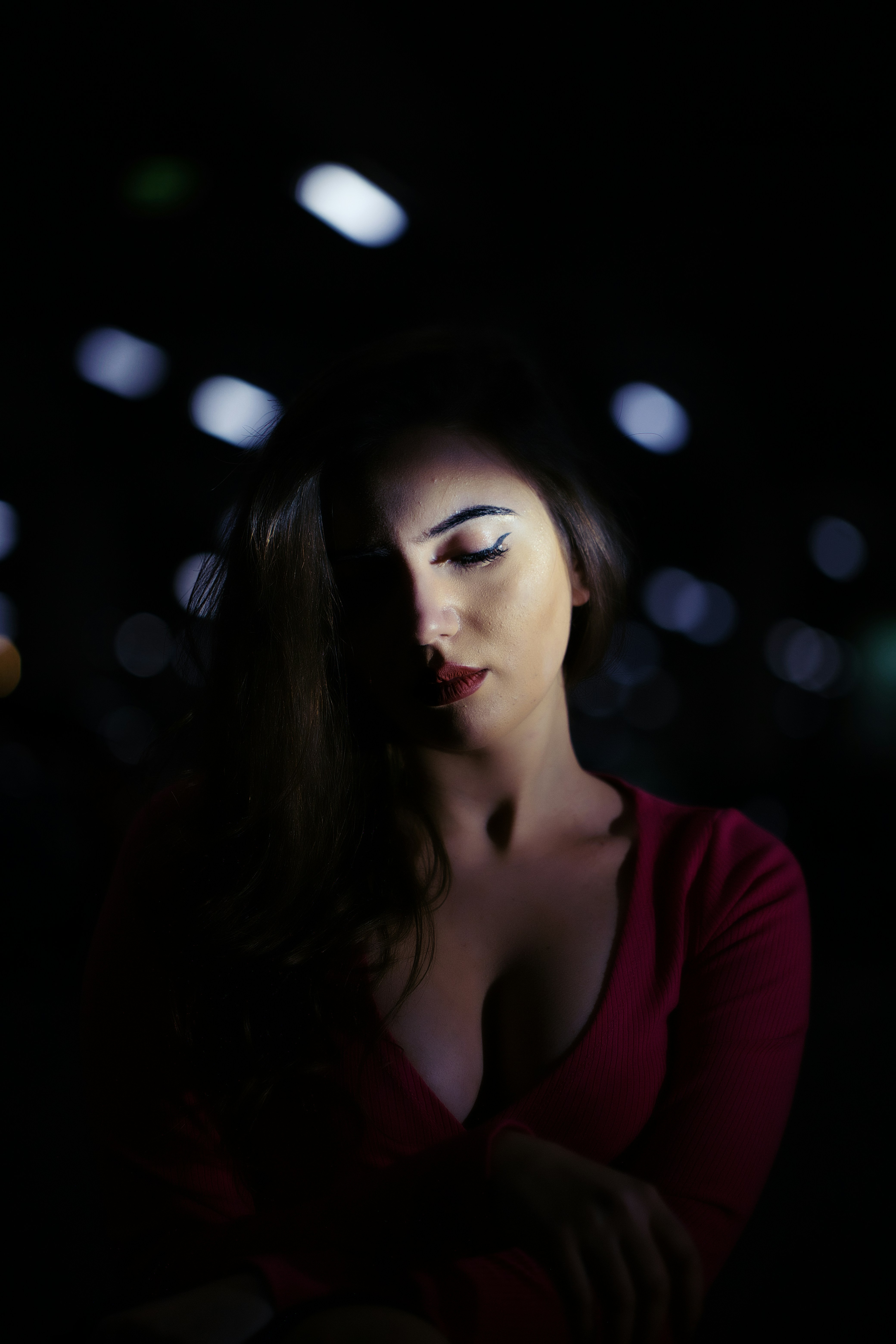 a woman in a red shirt is posing for a picture