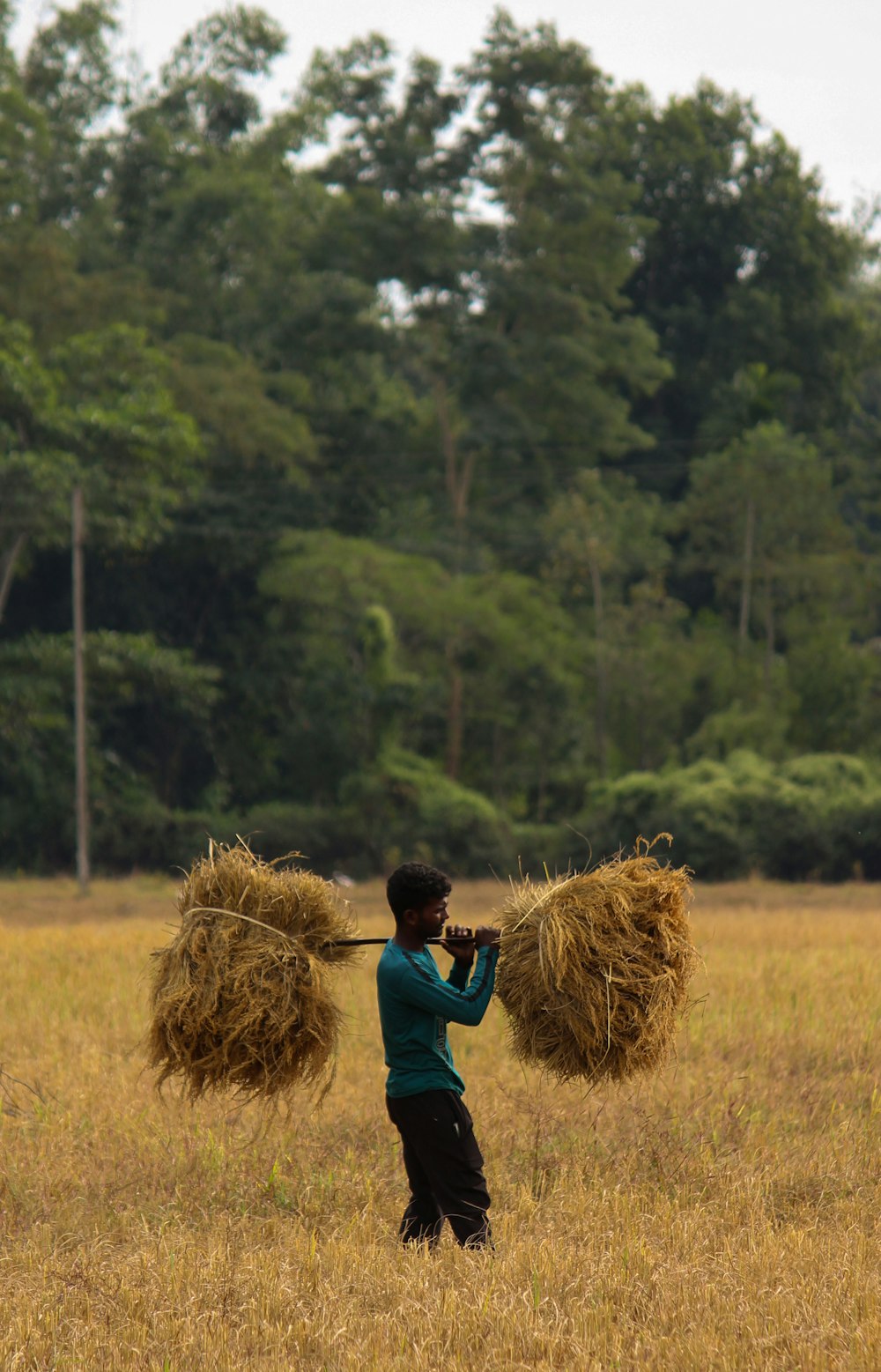 a man standing on top of a grass covered field